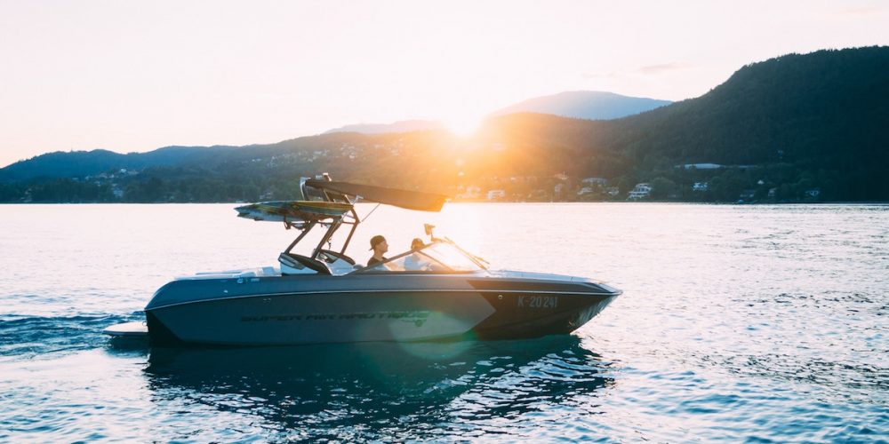 Young Couple In Boat At Sunset